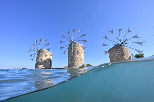 Split level underwater image of historical windmills of Chios Island, Greece