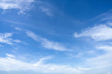 Fototapeta premium Blue sky and white cirrocumulus clouds texture background. Blue sky on sunny day. Summer sky. Cloud formation. Fluffy clouds. Nice weather in summer season. Weather pattern. Atmospheric phenomenon.