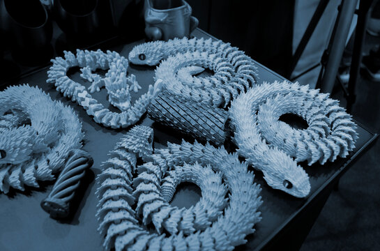 Art models printed on 3D printer. Different objects created on 3D printer from molten plastic. 3D printed different objects. Modern new modern additive progressive technologies. 3D printing technology