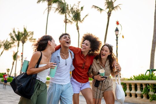 Diverse group of friends celebrates joy and togetherness while traveling, expressing pure happiness
