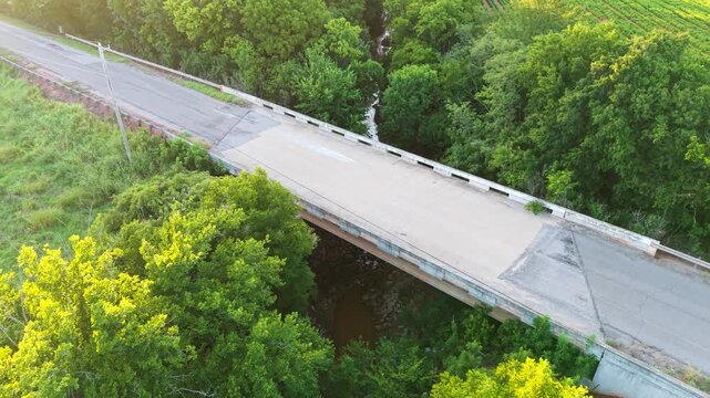 Aerial view of a concrete road bridge crossing a small creek in a rural area, Oklahoma