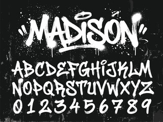Graffiti alphabet vector set with Madison title. Urban spray paint font on black background. Street art typography for apparel and posters. © PixelMark