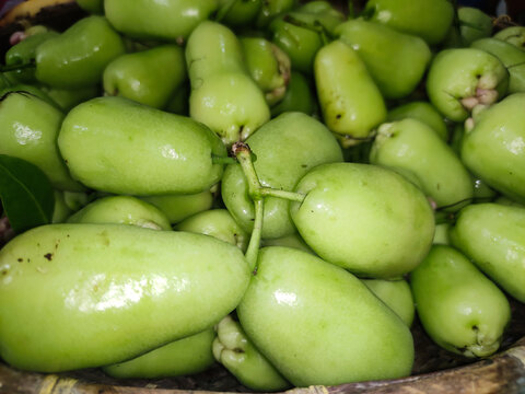 Fresh green water apples in a basket. Organic wax apples harvested for healthy nutrition.