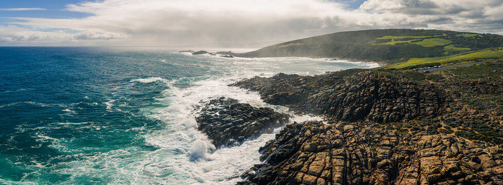 Aerial view of the rugged coastline and rocky formations at Canal Rocks Bridge with crashing waves and turquoise water in Yallingup, Western Australia, Australia.