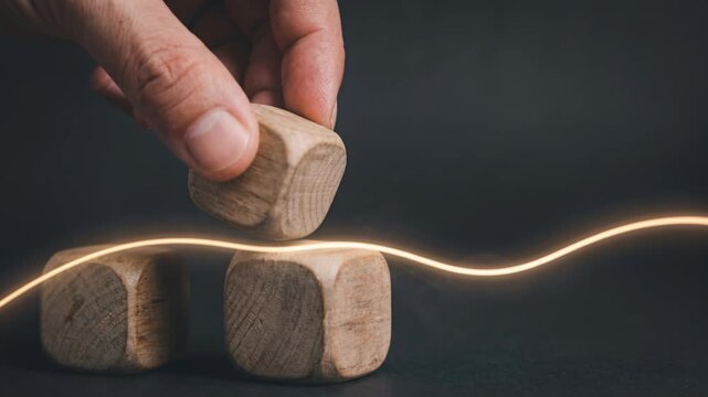 Business Trend Concept with Hand Arranging Wooden Blocks and Glowing Line