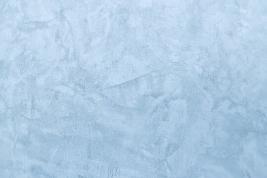 Light blue textured plaster background with abstract stucco pattern. Copy space 