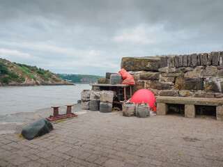 collection of old lobster and crab pots with disgarded equipment buoy float on quayside © Cliff
