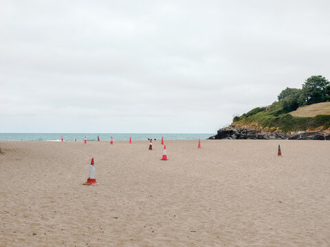 traffic cones mrking out safe pedestrian areas on a beach