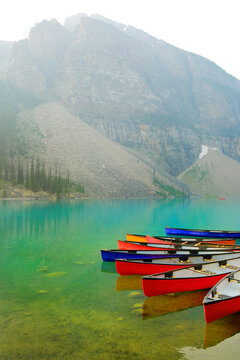 Red Canoes Docked at Moraine Lake in Banff National Forest in Alberta Canada