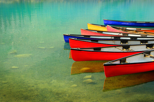 Red Canoes Docked at Moraine Lake in Banff National Forest in Alberta Canada