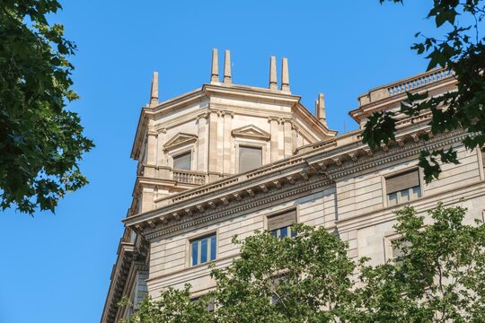 Neoclassical Building Tower and Facade Framed by Trees, Barcelona, Historic Stone Architecture
