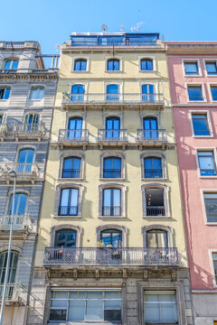 Yellow Residential Building Facade with Wrought Iron Balconies, Barcelona, Historic Architecture