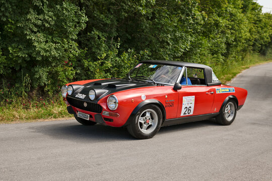 Vintage Fiat 124 Abarth racing car from 1973 driving during a classic car rally in Meldola, Italy, on June 2, 2013.