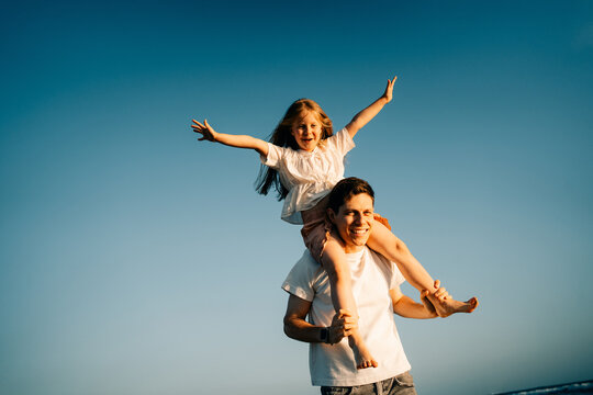 Father and Daughter Enjoy Time Together at the Beach in the Evening