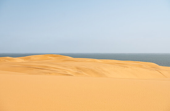 Sand dunes with vehicle tracks in the sand in the Namib desert just south of Walvis Bay, Namibia, Africa