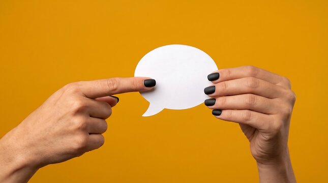 Hands holding a white speech bubble. Person pointing at a blank message cloud for text.