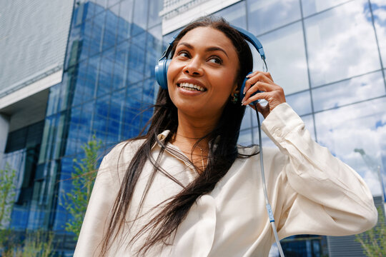 Woman listening to music with headphones in city