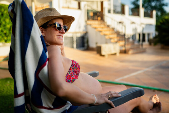 Pregnant woman relaxing sunbathing
