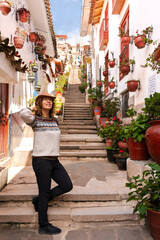Obraz premium Woman traveler visiting the colorful Siete Borreguitos street in Cusco Peru