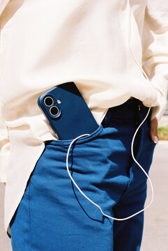 Blue Smartphone and earphones in pocket film photo