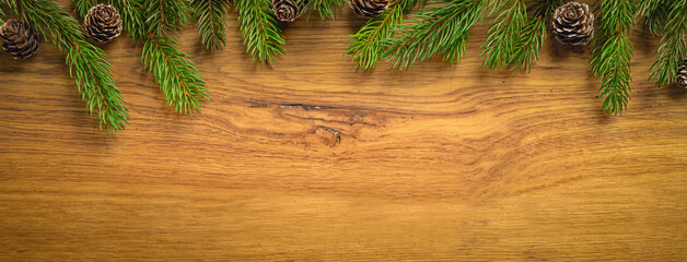 Obraz premium Christmas Pine Branches Framing Rustic Wooden Background