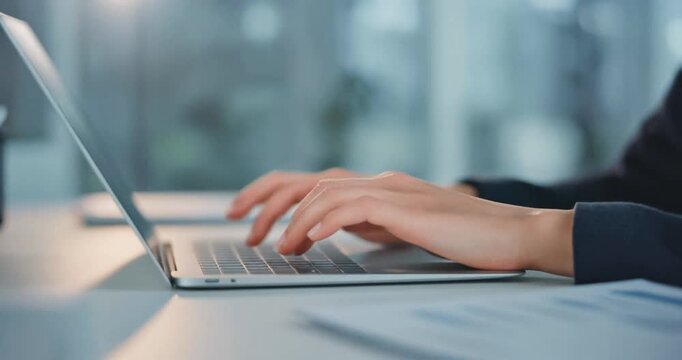 Person typing on laptop keyboard