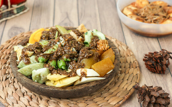 A traditional East Javanese dish, rujak cingur, made of assorted vegetables and slices of meat, all drenched in a rich peanut sauce flavored with petis (fermented fish paste). 