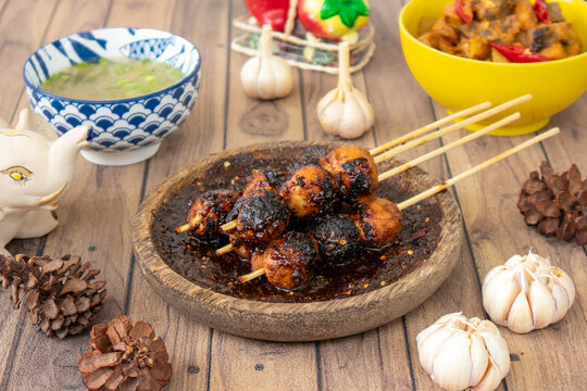 A popular Indonesian street food, bakso bakar&mdash;juicy grilled meatballs skewered and brushed with spicy sweet soy sauce. Smoky, savory, and slightly sweet.