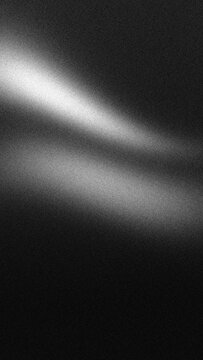 Monochrome grainy gradient background with white wavy light leak