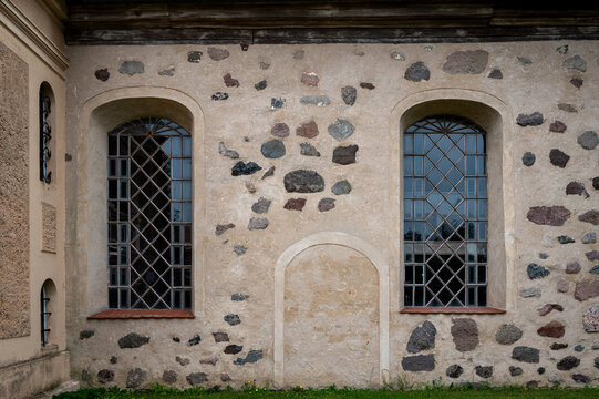 Historic fieldstone church wall with leaded windows in Wustrau
