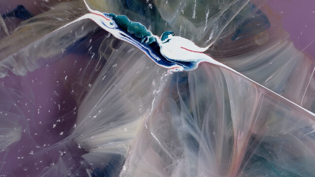 Art project using alcohol ink and epoxy resin on canvas in a workshop