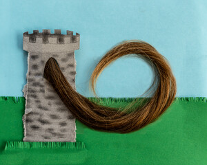Rapunzel is a European fairy tale. Maiden in tower. Prince climbs her hair. Paper and real human hair illustration. 