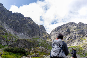 Fototapeta premium Hikers Watching Rescue Helicopter in High Tatra Mountains