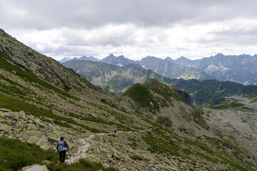 Fototapeta premium Hiker descending rocky mountain path in High Tatras
