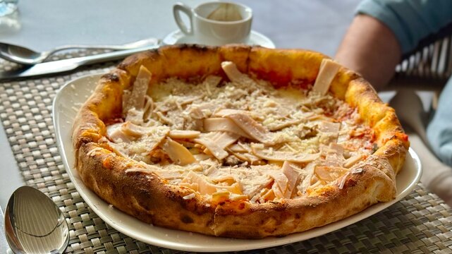 Thin Crust Pizza Served on Plate with Espresso on Table