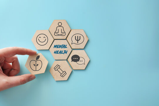 Hand Building Mental Health Concept With Wooden Hexagon Icons