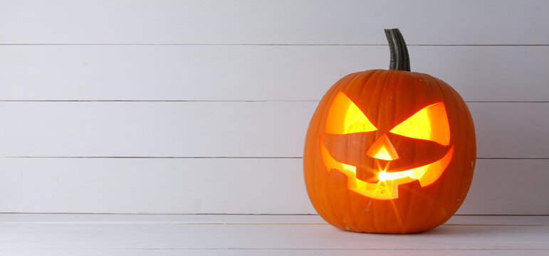 Halloween pumpkin lantern with burning candle inside