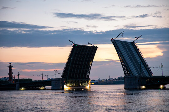 Palace Drawbridge opens during white nights over Neva river, engineering architecture in cityscape. Dvortsovy bridge - symbol of St. Petersburg. Travel agencies, guides, tour operators