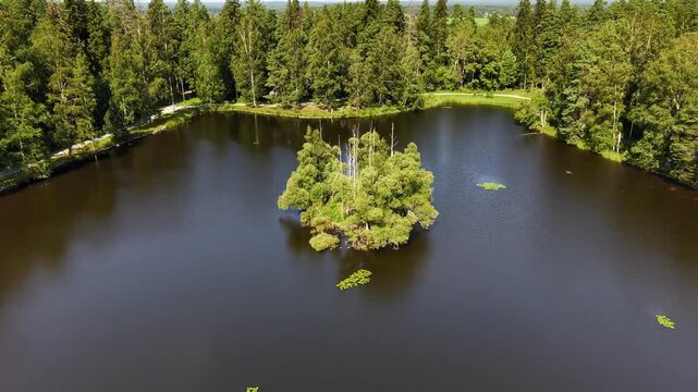 4K small island in Finland pond in H&auml;meenlinna Aulanko in aerial footage. 
