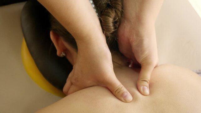 Close up shows therapist applying manual neck massage for tension relief. Professional wellness session supports mobility and comfort.