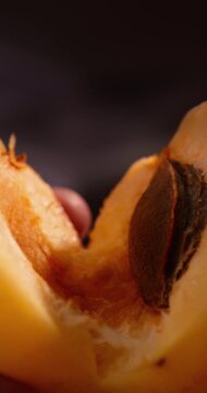 Fresh apricot being split in half. Juicy flesh, natural texture and ripe stone fruit, healthy food, agriculture, dessert and commercial advertising 