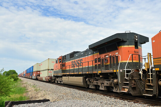 Multiple Burlington Northern Santa Fe locomotives help lead an eastbound stack train through north central Illinois.