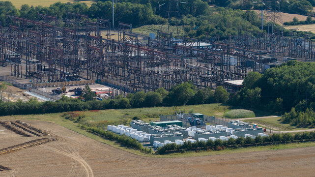 Aerial view of the Pelham Storage Limited battery facility and adjacent electrical substation, with rows of white storage containers in Bishop's Stortford, England, United Kingdom.