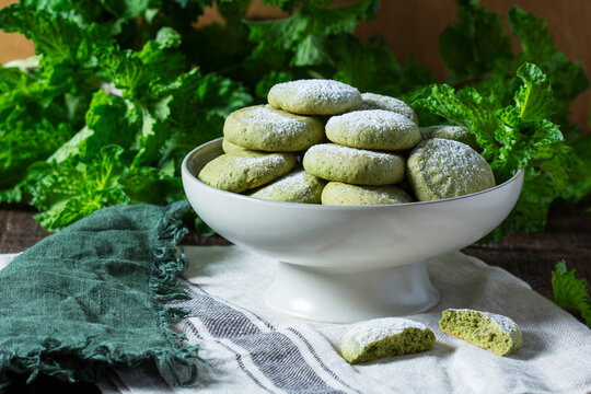 Homemade Mint Cookies Dusted with Powdered Sugar on Rustic Table