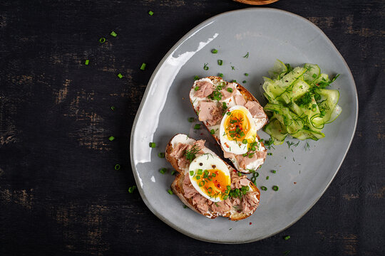 Healthy Tuna Toasts with Soft Boiled Egg and Cucumber Salad. Top view