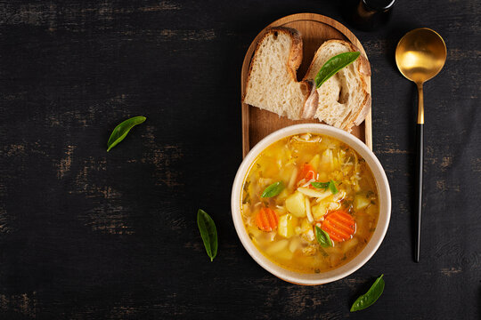 Homemade Chicken Orzo Soup with Vegetables and Fresh Bread