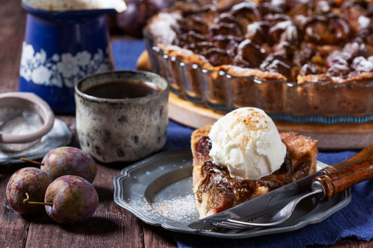 German plum cake with cinnamon, served with ice cream and coffee.