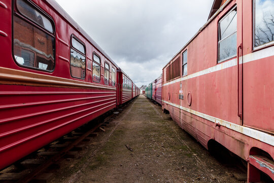 View of the historic Aukstaitija narrow gauge railway carriages parked on tracks under a cloudy sky in Panevezys, Panevezio apskritis, Lithuania.