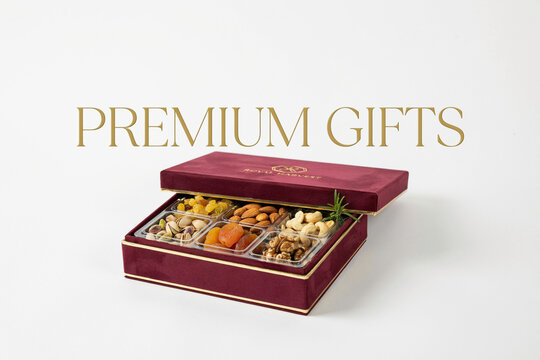 Elegant burgundy velvet gift box filled with an assortment of healthy nuts like pistachios almonds cashews walnuts and sweet dried fruits such as apricots and golden raisins a perfect gourmet present