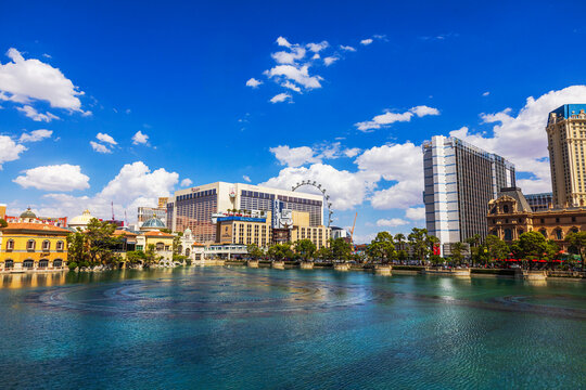 Beautiful view of Las Vegas Strip hotels and High Roller across Bellagio lake against blue sky. Las Vegas. USA. 